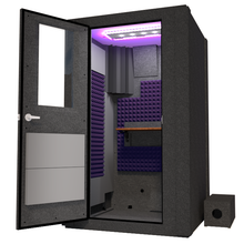 Load image into Gallery viewer, Angled view of WhisperRoom&#39;s Voice Over Basic Package - a 4&#39; x 4&#39; single-wall vocal booth, meticulously designed with acoustic treatment, a functional desk, studio lighting, and a comprehensive range of premium features. The left-hinged door is open, revealing the interior enhanced by elegant purple StudioFoam, creating an ideal recording atmosphere.
