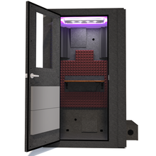 Load image into Gallery viewer, Frontal view of WhisperRoom&#39;s Voice Over Basic Package - a 4&#39; x 4&#39; single-wall vocal booth, thoughtfully equipped with acoustic treatment, a functional desk, studio lighting, and a range of premium features. The left-hinged door is open, revealing the interior accentuated with sophisticated burgundy StudioFoam, creating an inviting and professional recording space.
