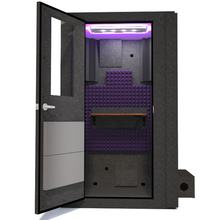 Load image into Gallery viewer, Front view of WhisperRoom&#39;s Voice Over Basic Package - a 4&#39; x 4&#39; single-wall vocal booth, thoughtfully equipped with acoustic treatment, a functional desk, studio lighting, and an array of premium features. The left-hinged door is open, revealing the interior accentuated with elegant purple StudioFoam, creating an inviting and professional recording environment.
