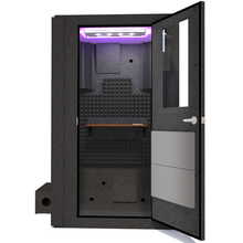 Load image into Gallery viewer, Front view of the WhisperRoom&#39;s Voice Over Basic Package - a 4&#39; x 4&#39; single-wall vocal booth, meticulously designed with acoustic treatment, a functional desk, studio lighting, and a range of premium features. The right-hinged door is open, revealing the interior adorned with sophisticated gray StudioFoam, creating an optimal recording environment.

