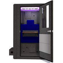 Load image into Gallery viewer, Front view of the WhisperRoom&#39;s Voice Over Basic Package - a 4&#39; x 4&#39; single-wall vocal booth, meticulously equipped with acoustic treatment, a functional desk, studio lighting, and an array of premium features. The right-hinged door is open, revealing the vibrant blue StudioFoam interior, creating an ideal recording space.
