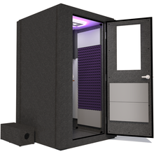 Load image into Gallery viewer, Side view of WhisperRoom&#39;s Voice Over Basic Package - a 4&#39; x 4&#39; single-wall vocal booth, thoughtfully equipped with acoustic treatment, a functional desk, studio lighting, and a variety of premium features. The right-hinged door is open, revealing the interior enhanced by elegant purple StudioFoam, creating an ideal recording atmosphere.
