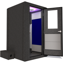 Load image into Gallery viewer, Side view of the WhisperRoom&#39;s Voice Over Basic Package - a 4&#39; x 4&#39; single-wall vocal booth, fully equipped with acoustic treatment, a functional desk, studio lighting, and an array of premium features. The right-hinged door is open, revealing the interior adorned with vibrant blue StudioFoam, providing an optimal recording environment.
