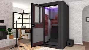 WhisperRoom's Voice Over Deluxe Package: A 4'x4' Double-Wall Vocal Booth equipped with Bass Traps, a Folding Office Desk, Burgundy Auralex StudioFoam, an Exterior Fan Silencer, Multi-Colored LED Studio Light, and an Acoustic Package, perfectly integrated into a living room home recording studio setup next to a fireplace with a chair at a desk, a laptop, and a complete various other equipment for voiceover.