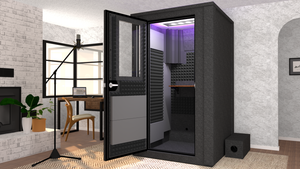 WhisperRoom's Voice Over Deluxe Package: A 4'x4' Double-Wall Vocal Booth equipped with Bass Traps, a Folding Office Desk, Gray Auralex StudioFoam, an Exterior Fan Silencer, Multi-Colored LED Studio Light, and an Acoustic Package, perfectly integrated into a living room home recording studio setup next to a fireplace with a chair at a desk, a laptop, and a complete various other equipment for voiceover.
