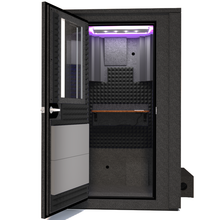 Load image into Gallery viewer, Frontal view of the WhisperRoom&#39;s Voice Over Deluxe Package - a 4&#39; x 4&#39; double-wall vocal booth, meticulously designed with acoustic treatment, a functional desk, studio lighting, and a comprehensive range of premium features. The left-hinged door is open, revealing the interior enhanced by sophisticated gray StudioFoam, creating an ideal recording environment.

