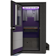 Load image into Gallery viewer, Frontal view of WhisperRoom&#39;s Voice Over Deluxe Package - a 4&#39; x 4&#39; double-wall vocal booth, meticulously designed with acoustic treatment, a functional desk, studio lighting, and a comprehensive range of premium features. The left-hinged door is open, revealing the interior enhanced by elegant purple StudioFoam, creating an ideal recording atmosphere.
