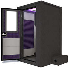 Load image into Gallery viewer, Side view of the WhisperRoom&#39;s Voice Over Deluxe Package - a 4&#39; x 4&#39; double-wall vocal booth, thoughtfully equipped with acoustic treatment, a functional desk, studio lighting, and an array of premium features. The left-hinged door is open, revealing the interior enhanced by elegant purple StudioFoam, creating an ideal recording atmosphere.
