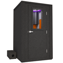 Load image into Gallery viewer, Frontal view of WhisperRoom&#39;s Voice Over Deluxe Package - a 4&#39; x 4&#39; double-wall vocal booth, meticulously designed with acoustic treatment, a functional desk, studio lighting, and a comprehensive range of premium features. The right-hinged door is closed, and the interior is enhanced by vibrant orange StudioFoam, creating an ideal recording environment.
