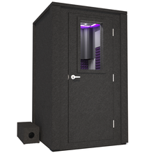 Load image into Gallery viewer, Frontal view of WhisperRoom&#39;s Voice Over Deluxe Package - a 4&#39; x 4&#39; double-wall vocal booth, meticulously designed with acoustic treatment, a functional desk, studio lighting, and a comprehensive range of premium features. The right-hinged door is closed, and the interior is enhanced by elegant purple StudioFoam, creating an ideal recording environment.
