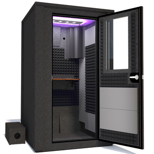 Angled view of the WhisperRoom's Voice Over Deluxe Package - a 4' x 4' double-wall vocal booth, thoughtfully equipped with acoustic treatment, a functional desk, studio lighting, and an array of premium features. The right-hinged door is open, revealing the interior enhanced by sophisticated gray StudioFoam, creating an ideal recording atmosphere.
