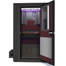 Load image into Gallery viewer, Frontal view of the WhisperRoom&#39;s Voice Over Deluxe Package - a 4&#39; x 4&#39; double-wall vocal booth, meticulously designed with acoustic treatment, a functional desk, studio lighting, and a comprehensive range of premium features. The right-hinged door is open, revealing the interior enhanced by sophisticated burgundy StudioFoam, creating an ideal recording atmosphere.
