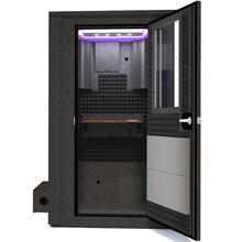 Load image into Gallery viewer, Frontal view of WhisperRoom&#39;s Voice Over Deluxe Package - a 4&#39; x 4&#39; double-wall vocal booth, meticulously designed with acoustic treatment, a functional desk, studio lighting, and a comprehensive range of premium features. The right-hinged door is open, revealing the interior enhanced by sophisticated gray StudioFoam, creating an ideal recording environment.
