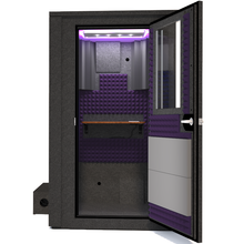 Load image into Gallery viewer, Frontal view of the WhisperRoom&#39;s Voice Over Deluxe Package - a 4&#39; x 4&#39; double-wall vocal booth, meticulously designed with acoustic treatment, a functional desk, studio lighting, and a comprehensive range of premium features. The right-hinged door is open, revealing the interior enhanced by elegant purple StudioFoam, creating an ideal recording atmosphere.
