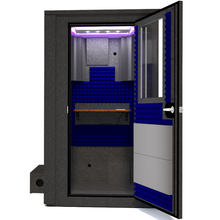 Load image into Gallery viewer, Frontal view of WhisperRoom&#39;s Voice Over Deluxe Package - a 4&#39; x 4&#39; double-wall vocal booth, meticulously designed with acoustic treatment, a functional desk, studio lighting, and a comprehensive range of premium features. The right-hinged door is open, revealing the interior accentuated with vibrant blue StudioFoam, creating an ideal recording environment.
