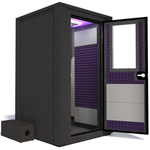 Load image into Gallery viewer, Side view of the WhisperRoom&#39;s Voice Over Deluxe Package - a 4&#39; x 4&#39; double-wall vocal booth, thoughtfully equipped with acoustic treatment, a functional desk, studio lighting, and an array of premium features. The right-hinged door is open, revealing the interior enhanced by elegant purple StudioFoam, creating an ideal recording atmosphere.
