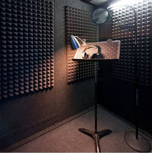 Three Gray Auralex Pyramid StudioFoam Sheets (2' x 4' x 2") Installed in a WhisperRoom with Microphone and Headphones on a Music Stand - Ideal Acoustic Treatment Setup for Recording and Sound Isolation.