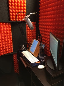 Orange Auralex Pyramid StudioFoam Sheets (2' x 4' x 2") Installed in WhisperRoom with Orange Foam, Microphone, Tablet, and Computer - Enhancing Acoustics for Professional Recording and Sound Isolation.